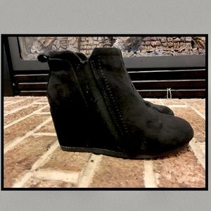 Girls black wedge boots.